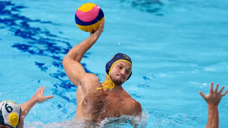 Alexey Shmider of Team Kazakhstan attacks under pressure from Lachlan Edwards (L) and Blake Edwards of Team Australia during the Men's Preliminary Round Group B match between Australia and Kazakhstan on day ten of the Tokyo 2020 Olympic Games.
