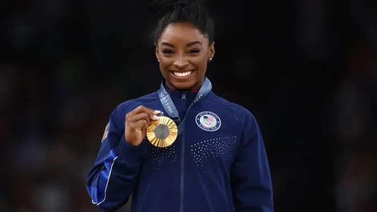 Gold medalist Simone Biles of Team United States celebrates on the podium during the medal ceremony for the Artistic Gymnastics Women's Vault Final on day eight of the Olympic Games Paris 2024 at Bercy Arena on August 03, 2024 in Paris, France.
