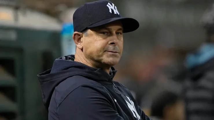 Aaron Boone #17 of the New York Yankees looks down into his bullpen against the Oakland Athletics in the bottom of the eighth inning at RingCentral Coliseum.
