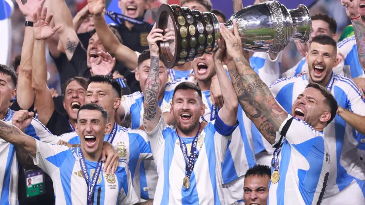 Angel Di Maria, Lionel Messi and Nicolas Otamendi of Argentina celebrate with the trophy after the team's victory in the CONMEBOL Copa America 2024 Final match between Argentina and Colombia at Hard Rock Stadium on July 15, 2024 in Miami Gardens, Florida.
