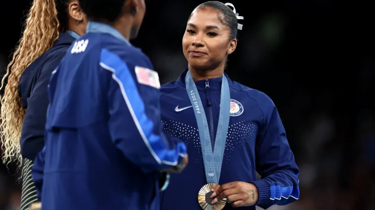 Gold medalist Rebeca Andrade (L) of Team Brazil, silver medalist Simone Biles (C) of Team United States and bronze medalist Jordan Chiles (R) of Team United States celebrate on the podium at the Artistic Gymnastics Women's Floor Exercise Medal Ceremony.
