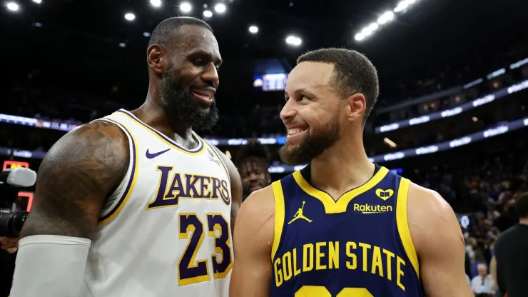 LeBron James (left) and Stephen Curry laughing after a game.
