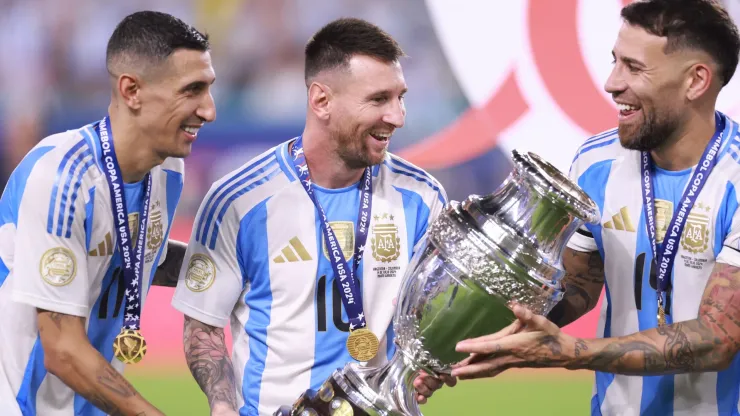 Angel Di Maria, Lionel Messi and Nicolas Otamendi of Argentina celebrate with the trophy after the team's victory in the CONMEBOL Copa America 2024 Final match between Argentina and Colombia at Hard Rock Stadium on July 15, 2024 in Miami Gardens, Florida.
