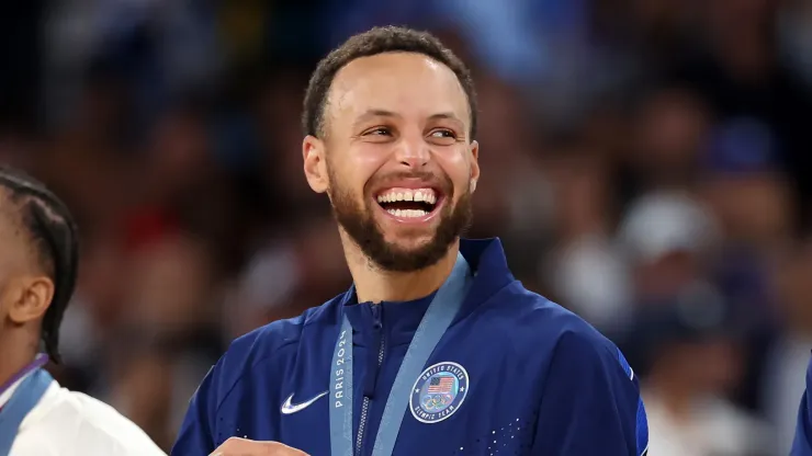 Gold medalist Stephen Curry of Team United States smiles on the podium
