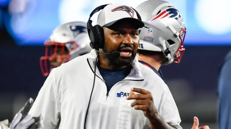 Head coach of the Jerod Mayo speaks to his staff during the second quarter of a preseason game against the Carolina Panthers at Gillette Stadium on August 08, 2024 in Foxborough, Massachusetts.
