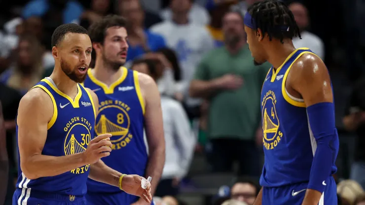 Stephen Curry #30 of the Golden State Warriors talks to teammate Moses Moody #4 during the fourth quarter against the Dallas Mavericks
