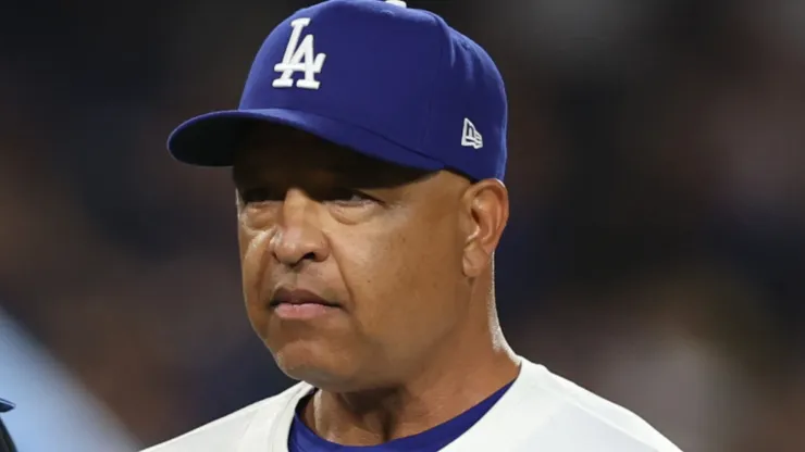 Manager Dave Roberts #30 of the Los Angeles Dodgers talks to umpire Tripp Gibson #73 during the eighth inning of Game Five of the Division Series against the San Diego Padres at Dodger Stadium on October 11, 2024 in Los Angeles, California. 
