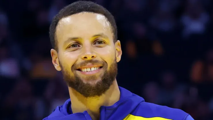 Jonnie West, the Warriors senior director of pro player personnel and son of Jerry West, presents Stephen Curry #30 of the Golden State Warriors the Jerry West Trophy as the Kia NBA Clutch Player of the Year last season before their preseason game against the Los Angeles Lakers at Chase Center on October 18, 2024 in San Francisco, California. 
