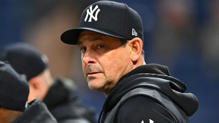 Manager Aaron Boone #17 of the New York Yankees during batting practice before Game Four of the American League Championship Series against the Cleveland Guardians at Progressive Field on October 18, 2024 in Cleveland, Ohio.
