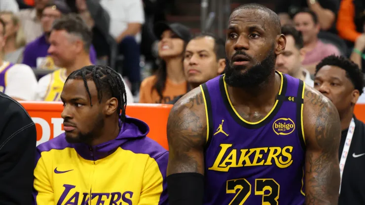 Bronny James #9 and LeBron James #23 of the Los Angeles Lakers look on during the second half against the Phoenix Suns
