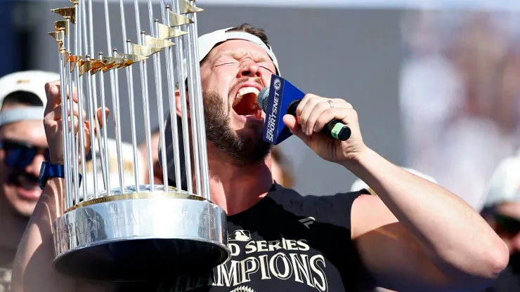  Clayton Kershaw #22 of the Los Angeles Dodgers celebrates with the Commissioners' Trophy during the 2024 World Series Celebration Show at Dodger Stadium on November 01, 2024 in Los Angeles, California.
