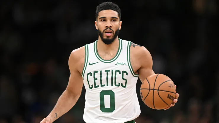 Jayson Tatum #0 of the Boston Celtics dribbles the ball up the court during the second half of a game against the Milwaukee Bucks
