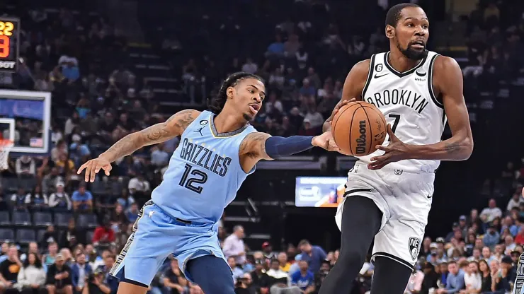 Kevin Durant #7 of the Brooklyn Nets goes to the basket against Ja Morant #12 of the Memphis Grizzlies during the game at FedExForum on October 24, 2022 in Memphis, Tennessee. 
