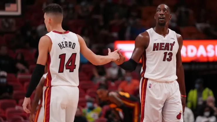 Tyler Herro #14 and Bam Adebayo #13 of the Miami Heat slaps hands in the second quarter against the Atlanta Hawks in preseason action at FTX Arena on October 04, 2021 in Miami, Florida. 
