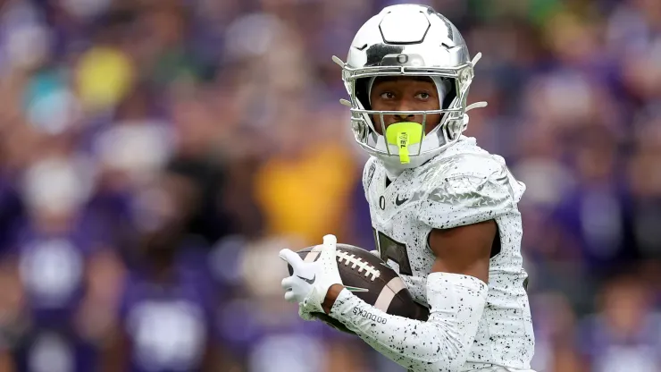 Tez Johnson #15 of the Oregon Ducks carries the ball against the Washington Huskies during the third quarter at Husky Stadium on October 14, 2023 in Seattle, Washington. 
