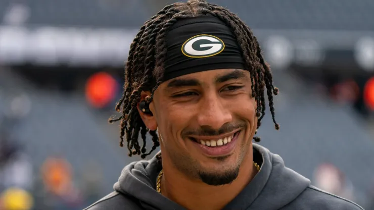 Jordan Love 10 of the Green Bay Packers smiles and walks on the sideline before the game between the Green Bay Packers and the Chicago Bears at Soldier Field on November 17, 2024.
