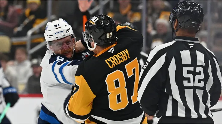 Sidney Crosby #87 of the Pittsburgh Penguins fights Kyle Connor #81 of the Winnipeg Jets in the third period during the game at PPG PAINTS Arena on November 22, 2024 in Pittsburgh, Pennsylvania.
