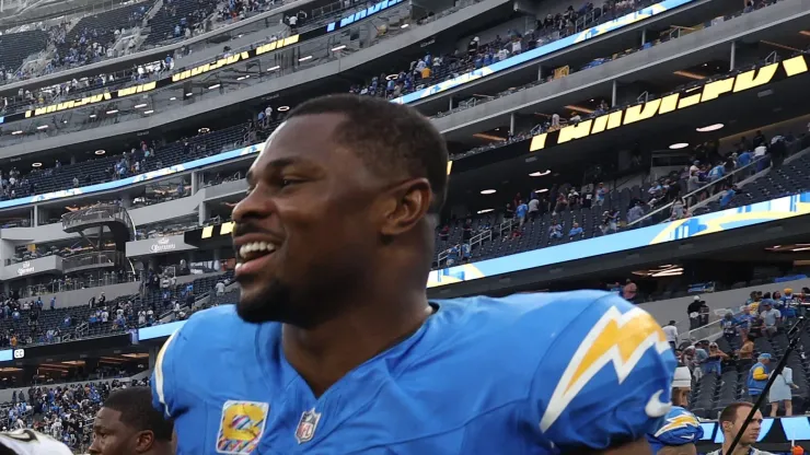 Alvin Kamara #41 of the New Orleans Saints and Khalil Mack #52 of the Los Angeles Chargers talk after Los Angeles' 26-8 win at SoFi Stadium on October 27, 2024 in Inglewood, California.
