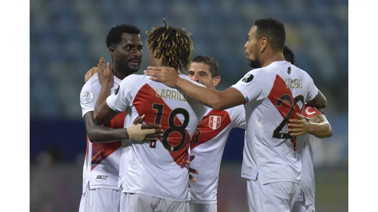 GOIANIA, BRAZIL - JUNE 20: Christian Ramos, André Carrillo and Alexander Callens of Peru celebrate with teammates after their second goal scored by an own goal of Yerry Mina of Colombia (not in frame) during a group B match between Colombia and Peru as part of Copa America Brazil 2021 at Estadio Olimpico on June 20, 2021 in Goiania, Brazil. (Photo by Pedro Vilela/Getty Images)
