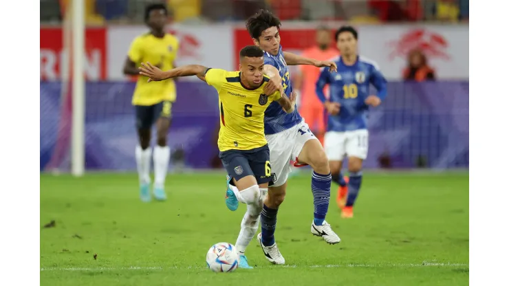 DUESSELDORF, GERMANY - SEPTEMBER 27: Byron Castillo of Ecuador battles for possession with Ao Tanaka of Japan during the international friendly match between Japan and Ecuador at Merkur Spiel-Arena on September 27, 2022 in Duesseldorf, Germany. (Photo by Alex Grimm/Getty Images)
