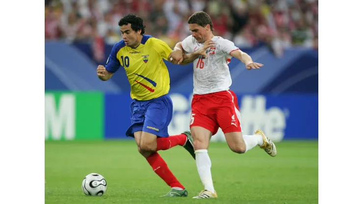 GELSENKIRCHEN, GERMANY - JUNE 09:  Arkadiusz Radomski of Poland and Ivan Kaviedes of Ecuador battle for the ball during the FIFA World Cup Germany 2006 Group A match between Poland and Ecuador at the Stadium Gelsenkirchen on June 9, 2006 in Gelsenkirchen, Germany.  (Photo by Laurence Griffiths/Getty Images)
