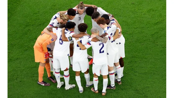 DOHA, QATAR - NOVEMBER 21:  Team United States huddle before the opening kickoff against Wales during the FIFA World Cup Qatar 2022 Group B match between USA and Wales at Ahmad Bin Ali Stadium on November 21, 2022 in Doha, Qatar. (Photo by Elsa/Getty Images)-Not Released (NR) Images cannot be used in books or individually in the form of mobile alert services or downloads without prior approval from FIFA
