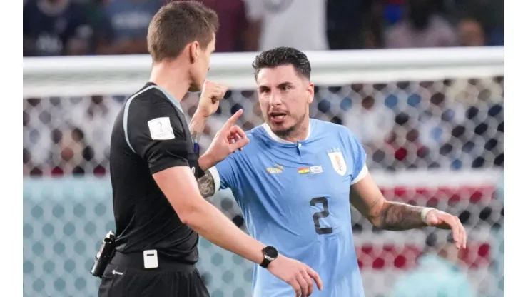 (221202) &#8212; AL WAKRAH, Dec. 2, 2022 &#8212; Jose Maria Gimenez (R) of Uruguay argues with referee Daniel Siebert after the Gr
