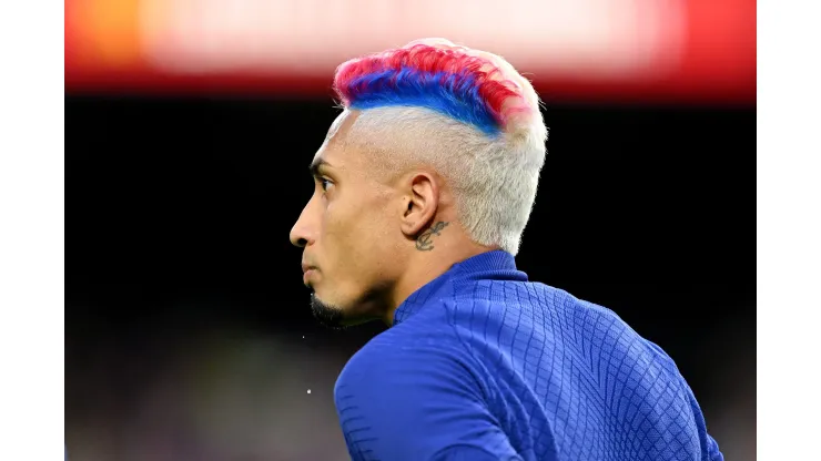 BARCELONA, SPAIN - MAY 20: Raphinha of FC Barcelona looks on, with a Blue and Red stripe in their hair, warms up prior to the LaLiga Santander match between FC Barcelona and Real Sociedad at Spotify Camp Nou on May 20, 2023 in Barcelona, Spain. (Photo by David Ramos/Getty Images)
