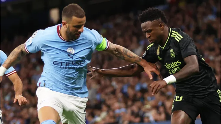 Vinicius Junior of Real Madrid by Kyle Walker of Manchester City . (Photo by Clive Brunskill/Getty Images)
