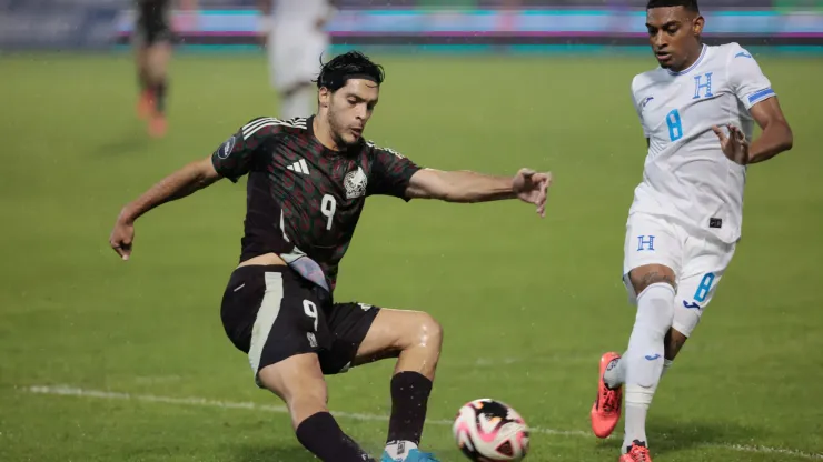 Raúl Jiménez of Mexico kicks the ball against Joseph Rosales of Honduras.
