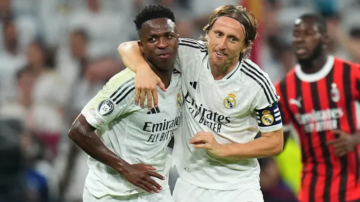 Vinicius Junior of Real Madrid celebrates with teammate Luka Modric after scoring his team's first goal from the penalty-spot during the UEFA Champions League 2024/25 League Phase MD4 match between Real Madrid C.F. and AC Milan at Estadio Santiago Bernabeu on November 05, 2024 in Madrid, Spain. 
