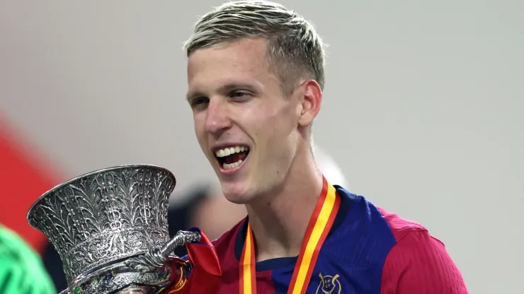 Dani Olmo of FC Barcelona celebrates with the Supercopa de Espana winners' trophy during the trophy presentation after the Spanish Super Cup Final between Real Madrid and FC Barcelona at King Abdullah Sports City on January 12, 2025 in Jeddah, Saudi Arabia.
