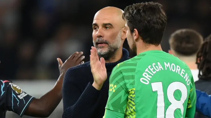 Manager of Manchester City, embraces Stefan Ortega of Manchester City after the team's victory in the Premier League match between Tottenham Hotspur and Manchester City at Tottenham Hotspur Stadium on May 14, 2024 in London, England.
