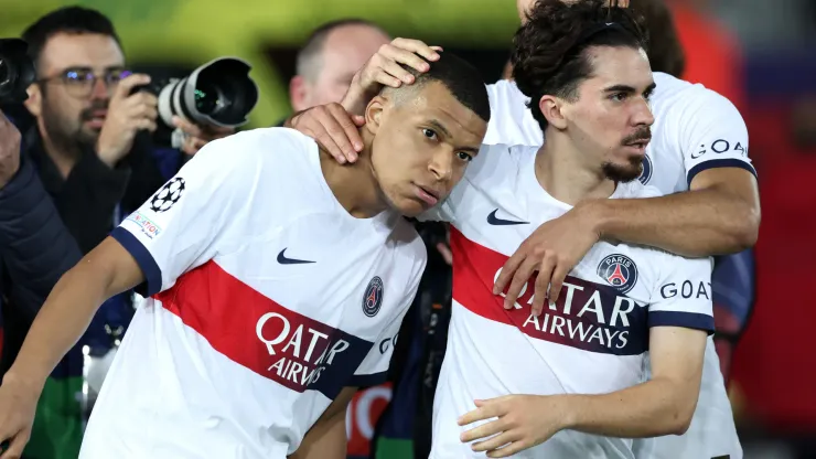 Kylian Mbappe of Paris Saint-Germain celebrates scoring his team's third goal from a penalty kick with teammate Vitinha during the UEFA Champions League quarter-final second leg match between FC Barcelona and Paris Saint-Germain at Estadi Olimpic Lluis Companys on April 16, 2024 in Barcelona, Spain.
