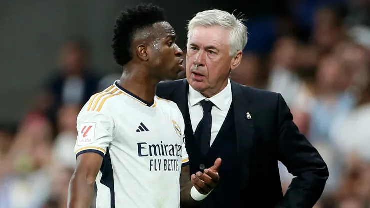 Vinicius Junior of Real Madrid interacts with Carlo Ancelotti, Head Coach of Real Madrid, after being substituted during the LaLiga EA Sports match between Real Madrid CF and FC Barcelona at Estadio Santiago Bernabeu on April 21, 2024 in Madrid, Spain. 
