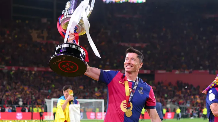 Robert Lewandowski of FC Barcelona celebrates with the Copa del Rey trophy after the team's victory in the Copa del Rey Final match between FC Barcelona and Real Madrid at Estadio de La Cartuja on April 26, 2025 in Seville, Spain.
