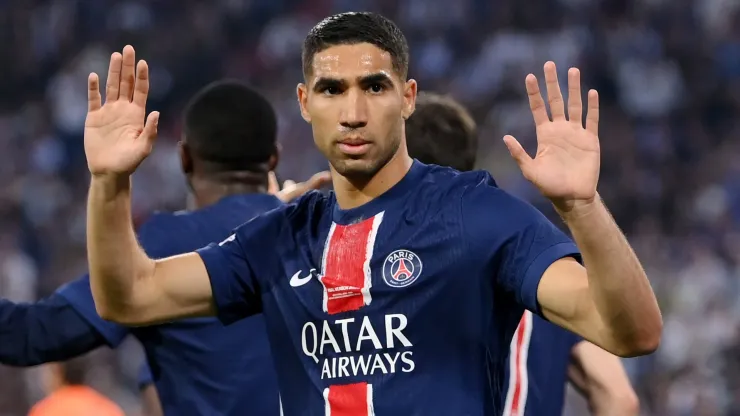 Achraf Hakimi of Paris Saint-Germain holds his hands up the FC Internazionale fans as he celebrates scoring his team's first goal during the UEFA Champions League Final 2025 between Paris Saint-Germain and FC Internazionale Milano at Munich Football Arena on May 31, 2025 in Munich, Germany.
