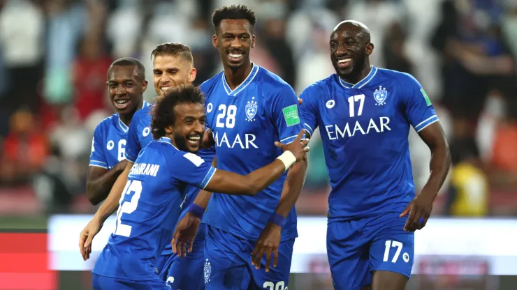 Mohamed Kanno celebrates with teammates Moussa Marega and Yasir Alshahrani of Al Hilal after scoring their team's third goal during the FIFA Club World Cup UAE 2021 2nd Round match in 2022.
