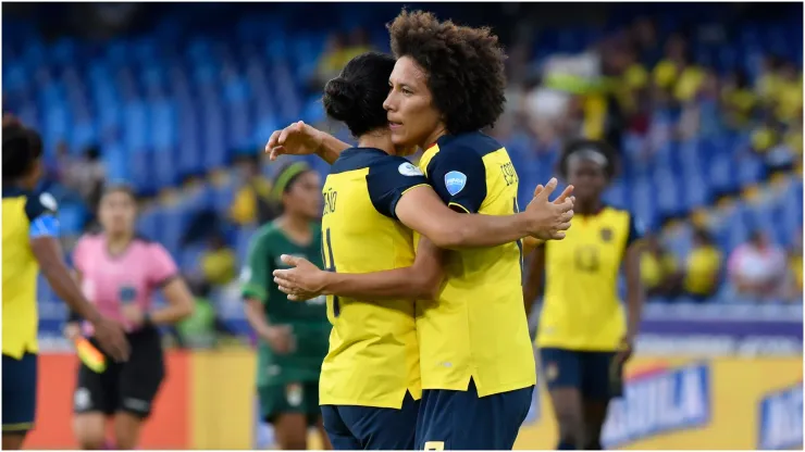 Emily Arias of Ecuador celebrates with teammate
