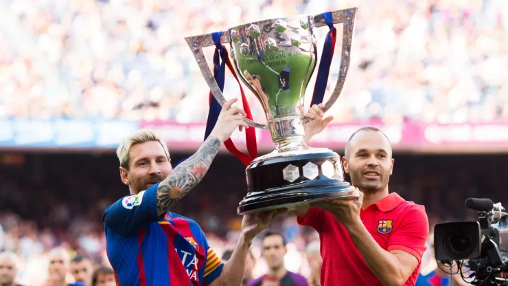 Lionel Messi and Andres Iniesta of FC Barcelona lift up the Spanish La Liga 2015-2016 season trophy before the La Liga match between FC Barcelona and Real Betis Balompie at Camp Nou on August 20, 2016.
