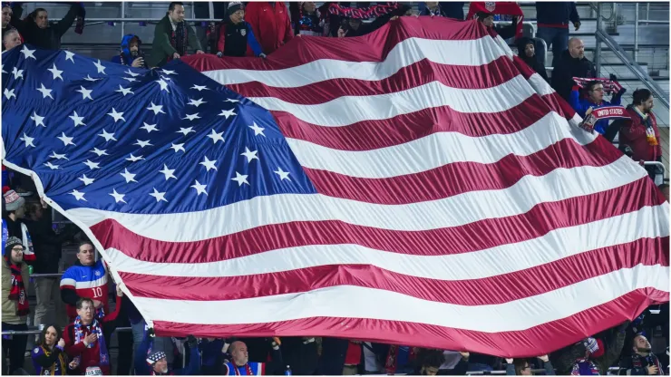 Fans of the United States hold a flag
