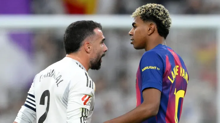 Dani Carvajal of Real Madrid clashes with Lamine Yamal of FC Barcelona.

