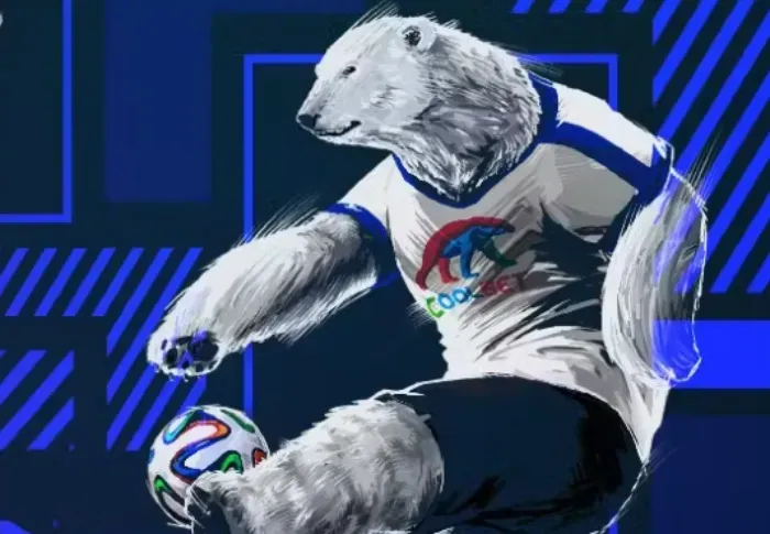 Mascota de Coolbet pateando balón de fútbol 