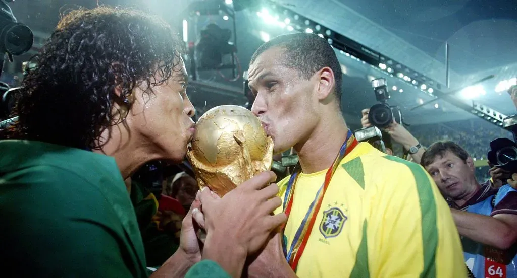 Brazil players Ronaldinho and Rivaldo kiss the World Cup trophy after beating Germany in the final. Yokohama, Japan, June 30, 2002.