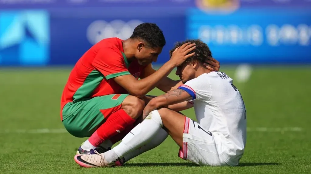 ACHRAF HAKIMI comforts KEVIN PAREDES (USA) with post game despair during a Olympics- Quarter Final game, Morocco versus USA, at Parc De Princes.