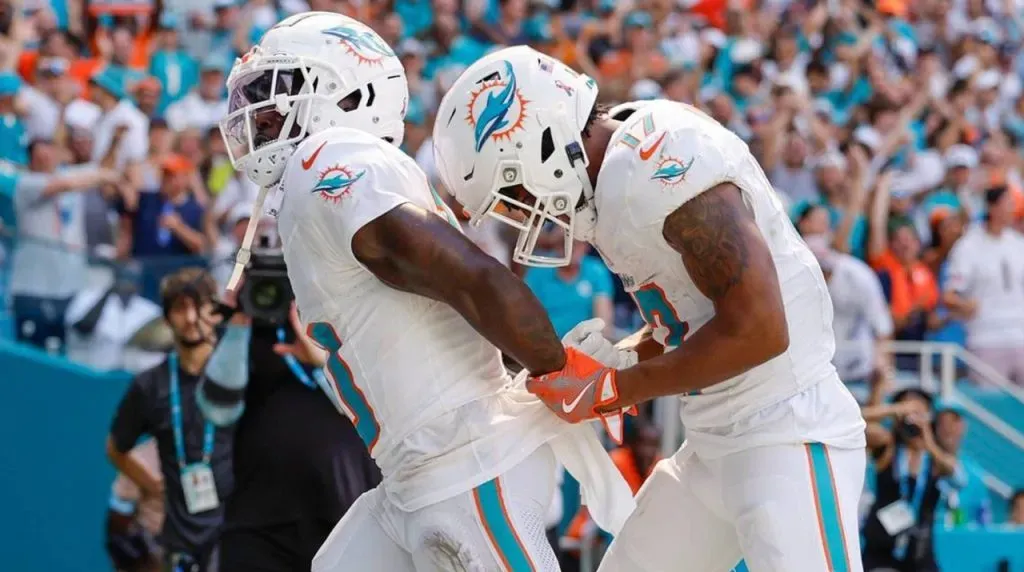 Miami Dolphins wide receiver Tyreek Hill (10) holds his hands behind his back as if he is handcuffed as wide receiver Jaylen Waddle (17) unlocks them after Waddle scores in the second half against the Jacksonville Jaguars at Hard Rock Stadium in Miami Gardens, Florida, on Sunday, Sept. 8, 2024.