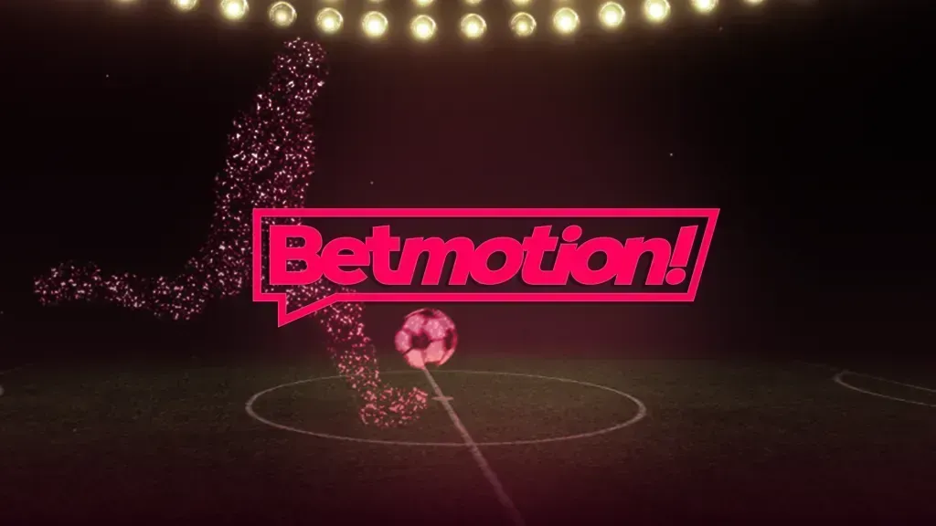 Imagem escura de um jogador de futebol composto por luzes, que chuta uma bola do meio-campo, e logo da Betmotion! ao centro em caracteres rosa