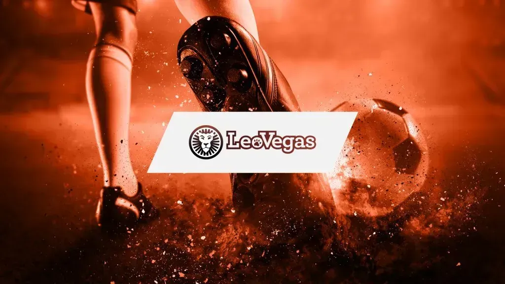 Imagem em tons de laranja, com grande plano de atleta com chuteiras e bola de futebol, e logo da LeoVegas