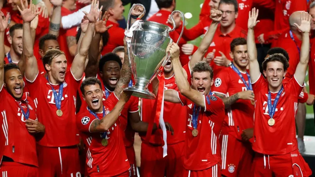 Philippe Coutinho and Thomas Mueller of FC Bayern Munich lift the UEFA Champions League Trophy following their team’s victory in the UEFA Champions League Final in 2020. (Source: Matt Childs/Pool via Getty Images)