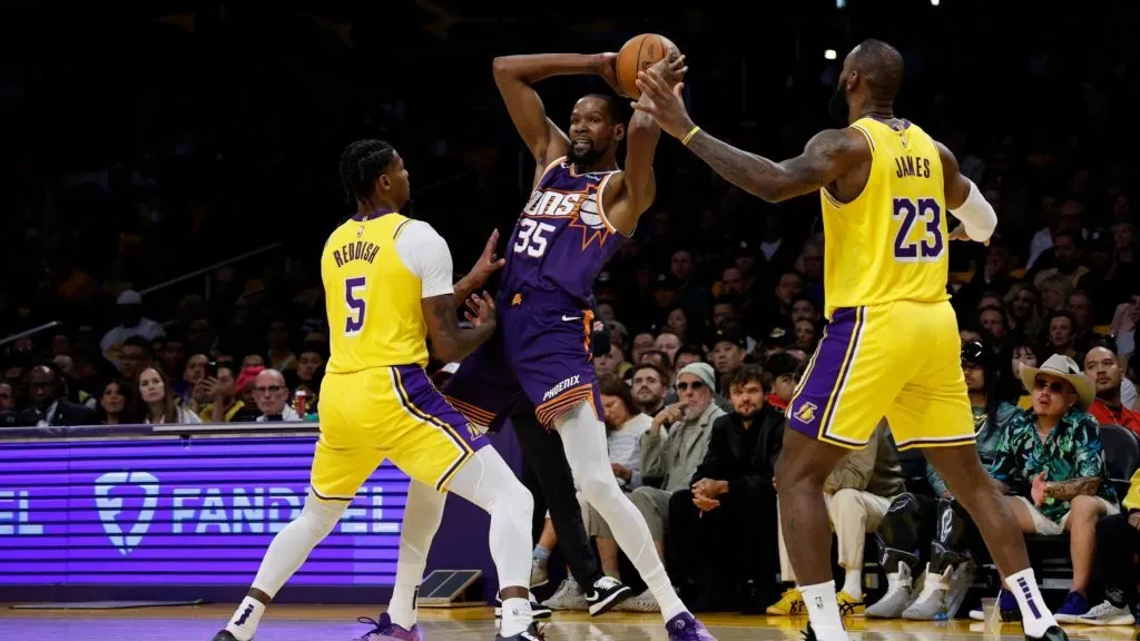 Kevin Durant defended by Cam Reddish and LeBron James during the first half at Crypto.com Arena on October 26, 2023 in Los Angeles, California.